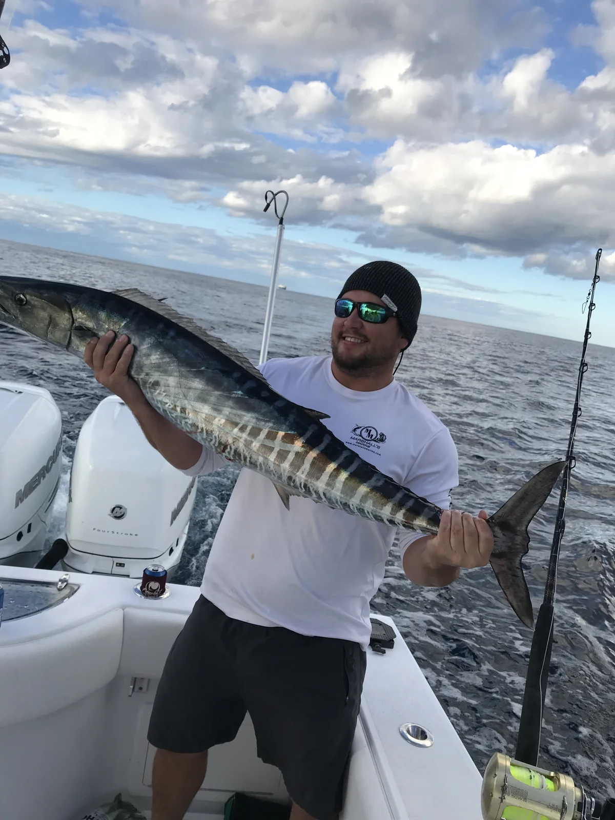 A wahoo with its distinct tiger-stripe pattern, boatside